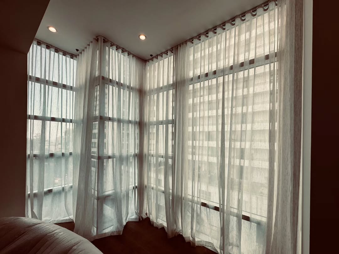 Sheer ripplefold drapes on floor-to-ceiling corner windows in a West LA high-rise